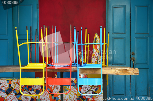 Image of Colorful chairs on a wooden table 