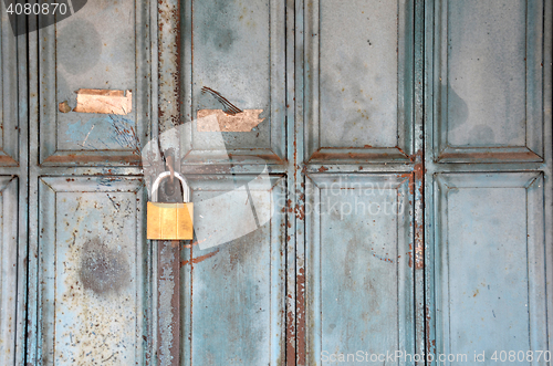 Image of Metal lock on a blue door