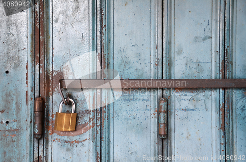 Image of Metal lock on a blue door