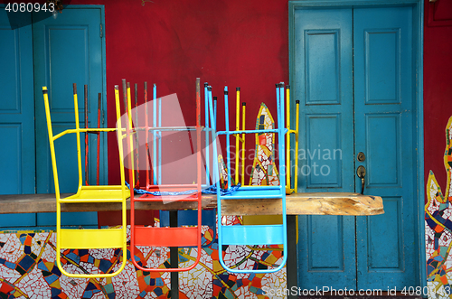 Image of Colorful chairs on a wooden table