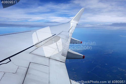 Image of Wing of an airplane on blue sky