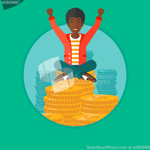 Image of Happy businessman sitting on coins.