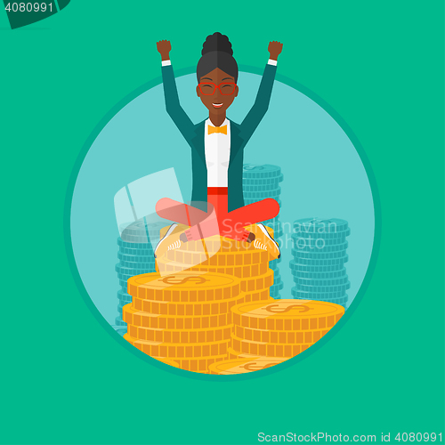 Image of Happy business woman sitting on coins.