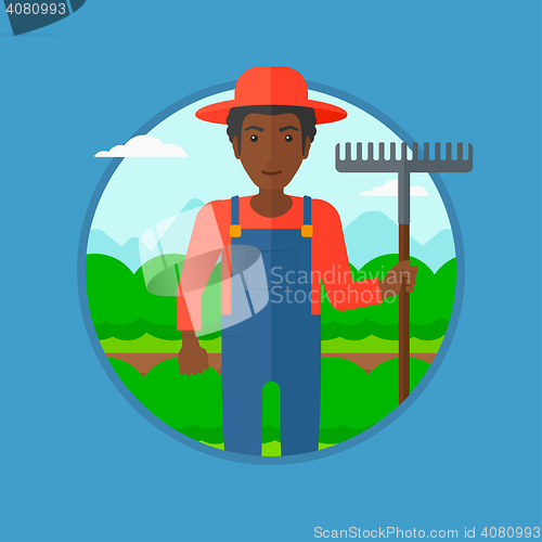 Image of Farmer with rake at cabbage field.