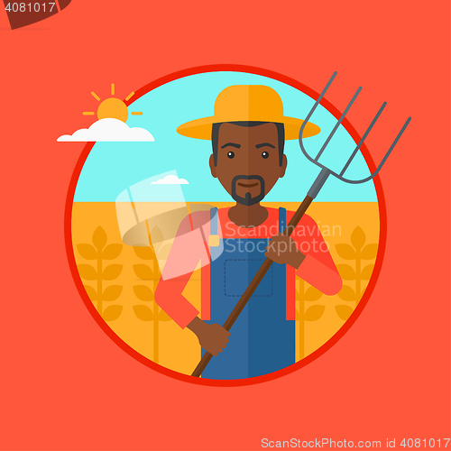 Image of Farmer with pitchfork in wheat field.