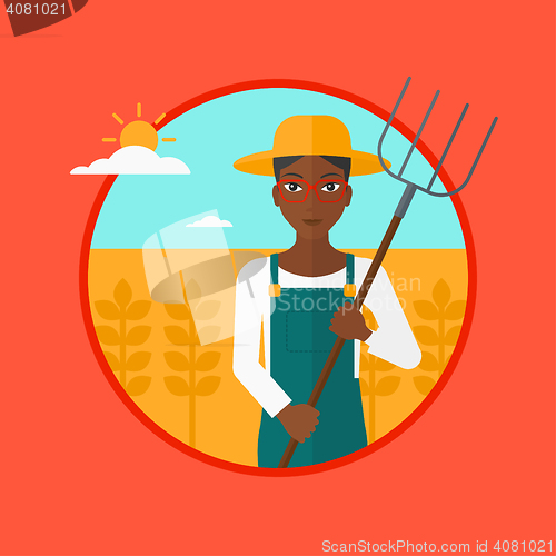 Image of Farmer with pitchfork in wheat field.