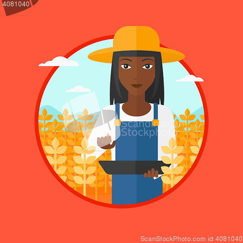 Image of Farmer with tablet computer on field.