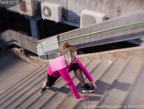 Image of woman  stretching before morning jogging