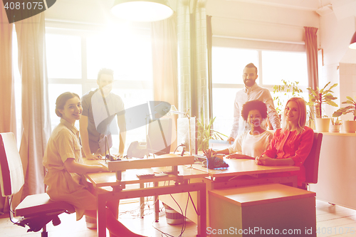 Image of happy creative team in office