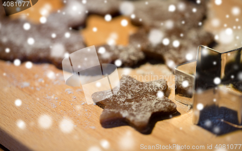 Image of close up of ginger dough, molds and flour on board