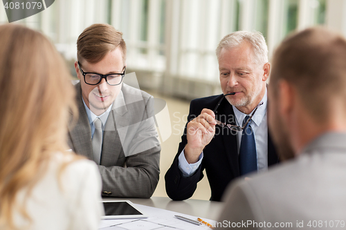 Image of architects with tablet pc and blueprint at office