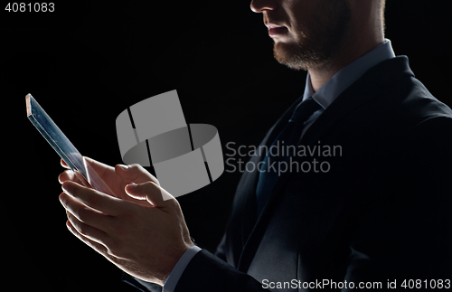 Image of close up of businessman with transparent tablet pc