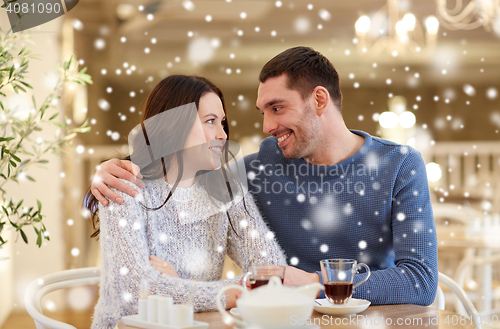 Image of happy couple drinking tea at restaurant