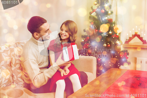 Image of smiling father and daughter looking at each other