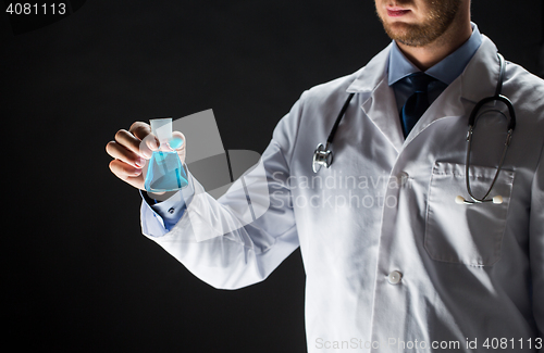 Image of close up of doctor holding flask with cure vaccine