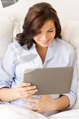 Image of happy pregnant woman with tablet pc at home