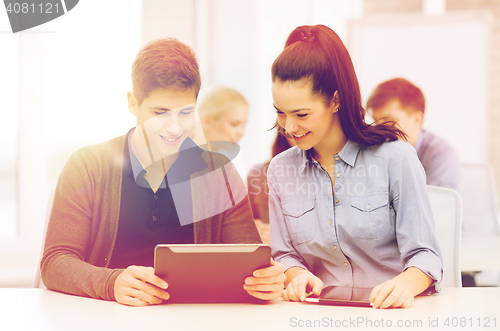 Image of students looking at tablet pc in lecture at school