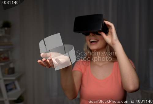 Image of happy woman in virtual reality headset or glasses 