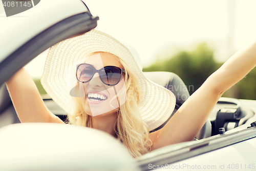 Image of happy woman driving in cabriolet car