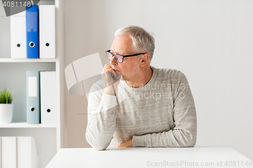 Image of senior man sitting at table