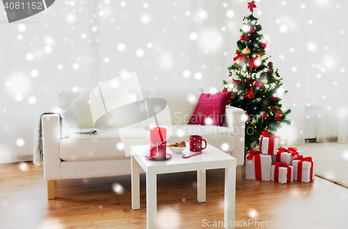 Image of living room interior with christmas tree and gifts