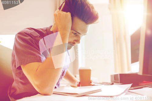Image of creative male office worker with coffee thinking