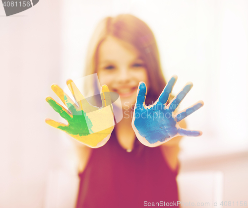 Image of happy girl showing painted hands