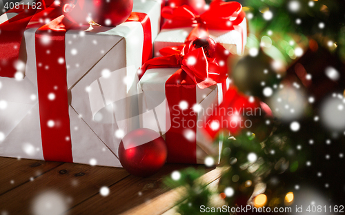 Image of gift boxes and red balls under christmas tree