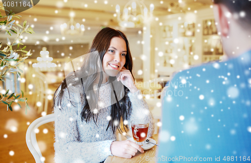 Image of happy couple drinking tea at cafe