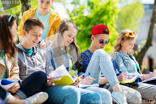 Image of group of students with notebooks at school yard