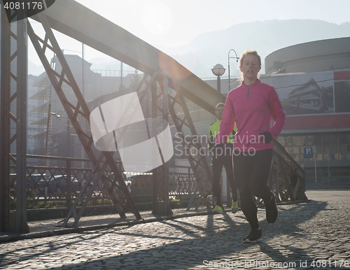 Image of sporty woman jogging on morning