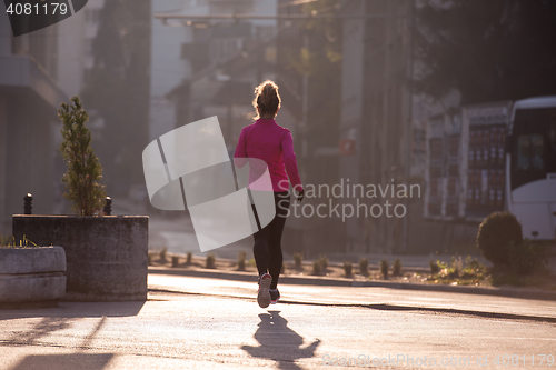 Image of sporty woman jogging on morning