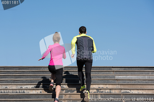 Image of young  couple jogging on steps