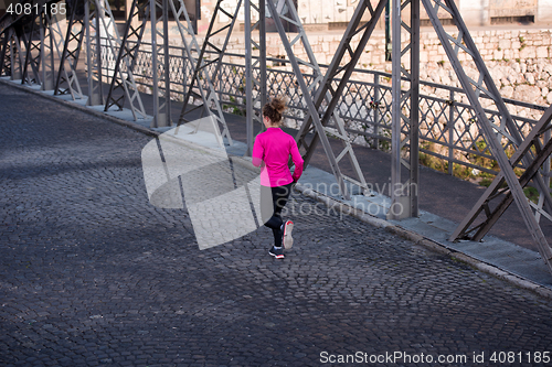 Image of sporty woman jogging on morning