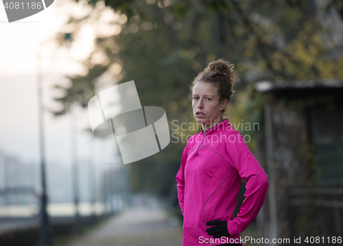 Image of woman  stretching before morning jogging