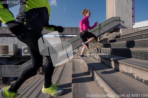 Image of young  couple jogging on steps