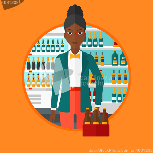 Image of Woman with pack of beer at supermarket.
