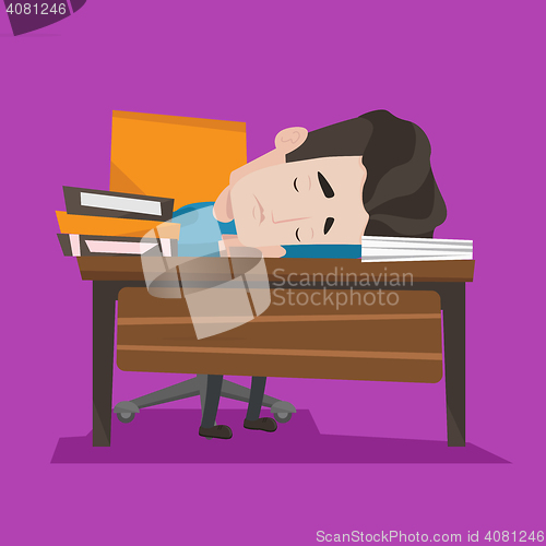 Image of Male student sleeping at the desk with book.