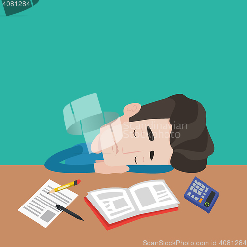 Image of Male student sleeping at the desk with book.