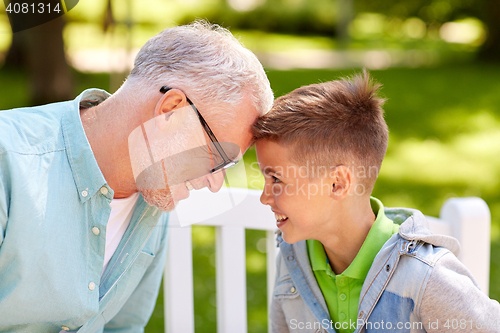 Image of grandfather and grandson at summer park