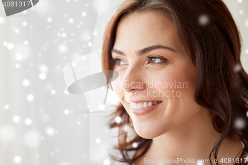 Image of close up of woman looking through window at home