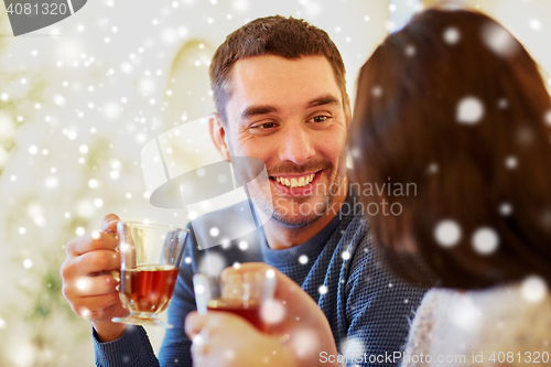 Image of happy couple drinking tea at cafe