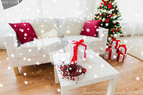 Image of close up of christmas gift box on table at home