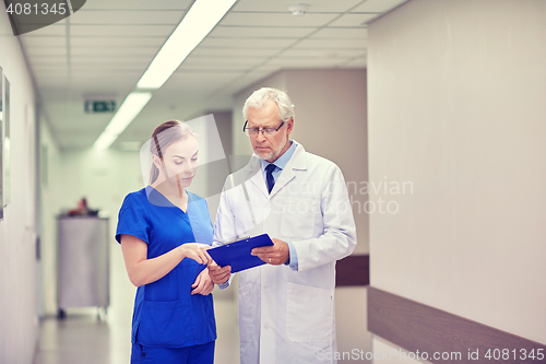 Image of senior doctor and nurse with tablet pc at hospital