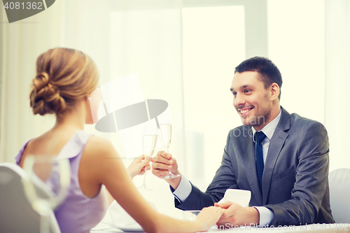 Image of couple with glasses of champagne at restaurant