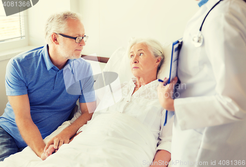 Image of senior woman and doctor with clipboard at hospital