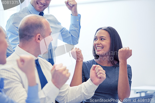 Image of smiling business people meeting in office