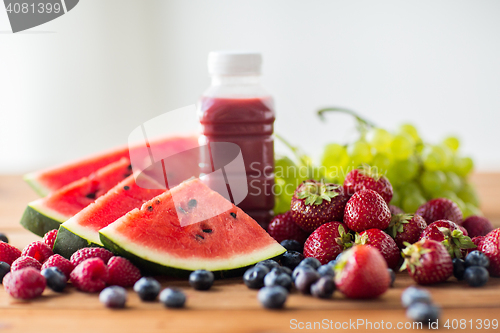 Image of bottle with fruit and berry juice or smoothie