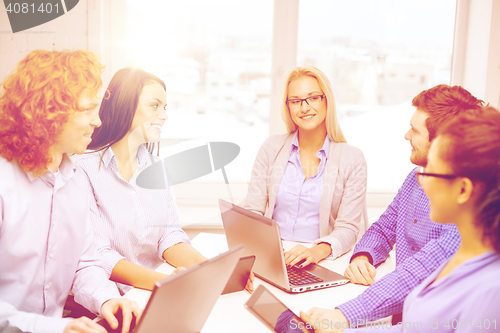 Image of smiling team with laptop and table pc computers