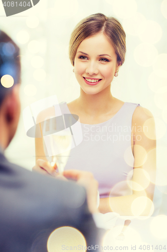 Image of couple with glasses of champagne at restaurant